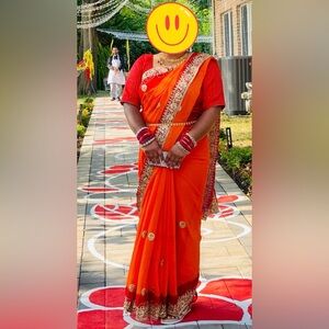 Vibrant Orange and Red Sari with Gold Accents